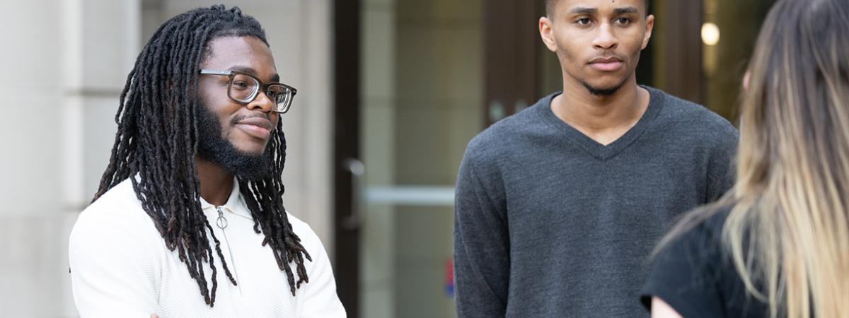 Students having a conversation outside a law school building.