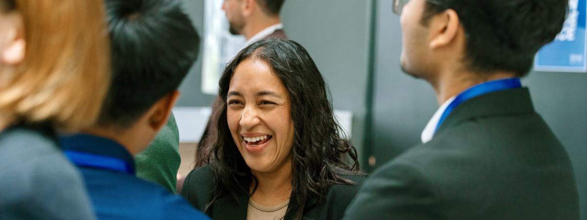 A student laughs with a group of peers.