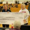 Michael Scharf receives scholarship check