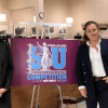 Vincent Romero and Kristen Mehalko posing by a purple sign with the details of the competition
