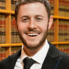 Yaron Covo headshot with library stacks behind him