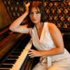 Sophia sitting at a piano
