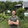 Logan Byler standing in front of a sign for the Western Land Conservancy