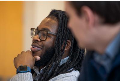 A student looks engaged and smiling during a class.