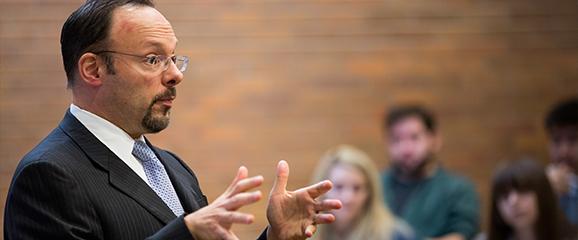 image of Jonathan Adler teaching class with law students in background