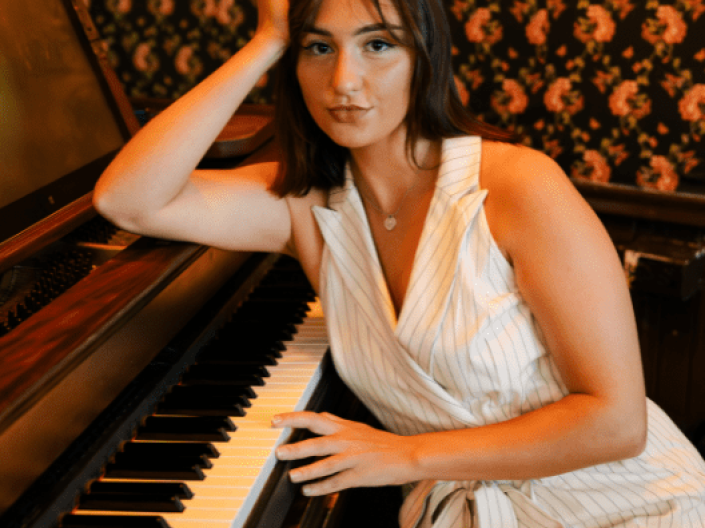 Sophia sitting at a piano