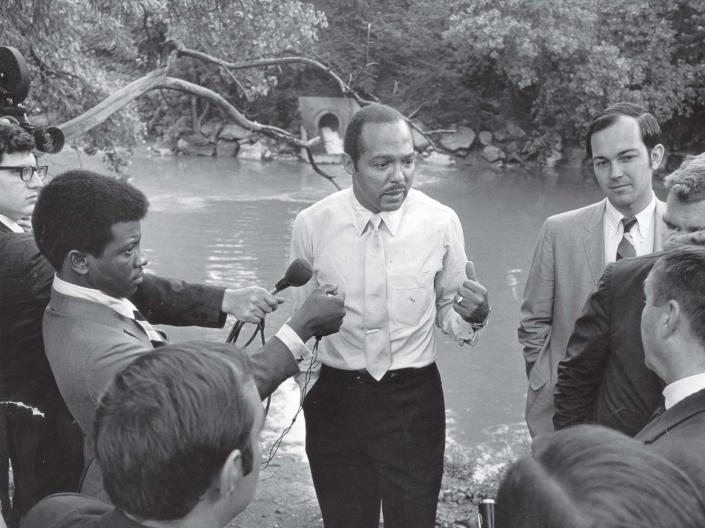 Photo of Carl Stokes speaking to reporters