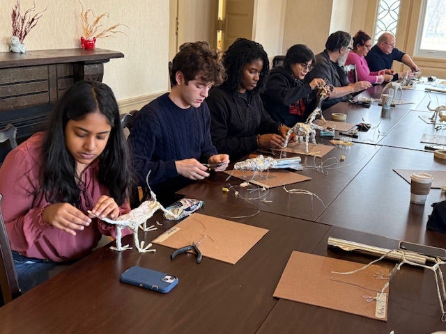 Student and staff making Alebrijes sculptures. 