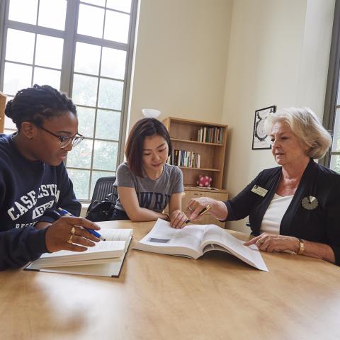 librarian assisting two students