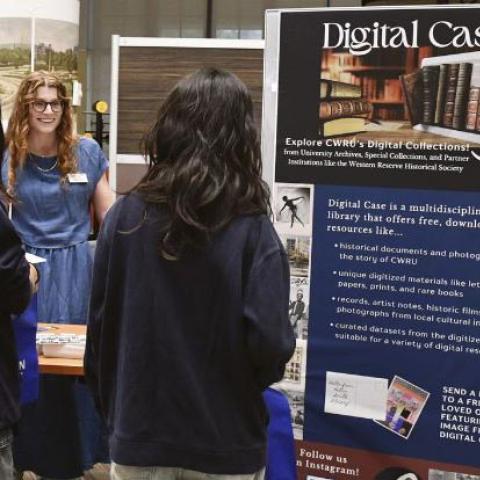 Student interacting with librarian at InfoFair