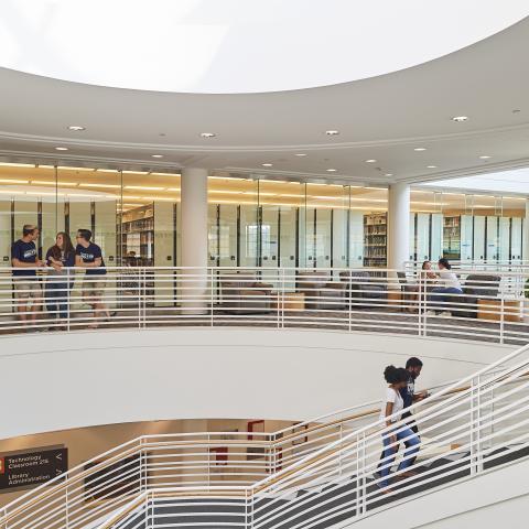 students walking up stairs in the library