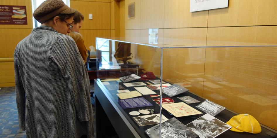People look at University Archives exhibit case at Kelvin Smith Library.