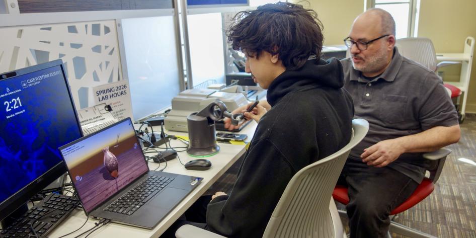 Freedman Center staff works with student at computer