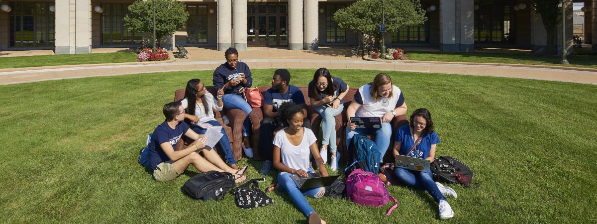 Students Sitting on the Oval in front of Kelvin Smith Library