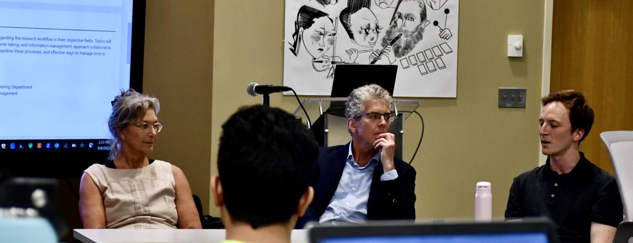 Three panelists speak in the Freedman Center at Kelvin Smith Library.