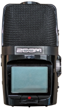 Handheld audio recorder with small screen at bottom and microphone at top.