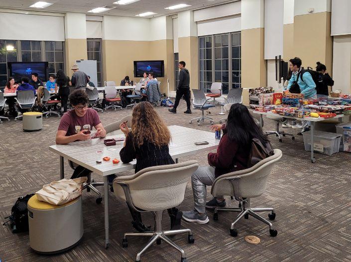 students sitting at tables playing games