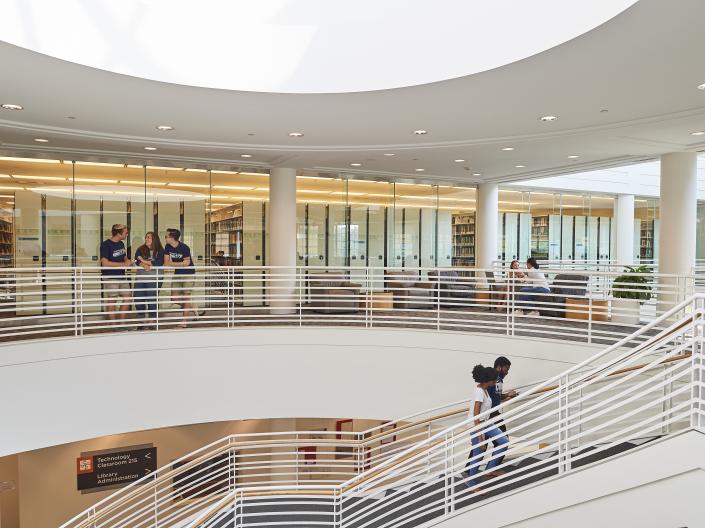 students walking up stairs in the library