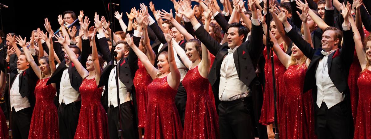 Singing Hoosiers extending their arms while singing