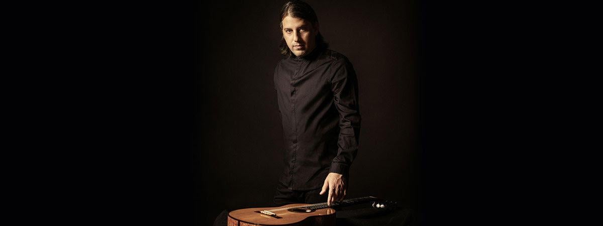 Tal Hurwitz, in black, right hand on guitar