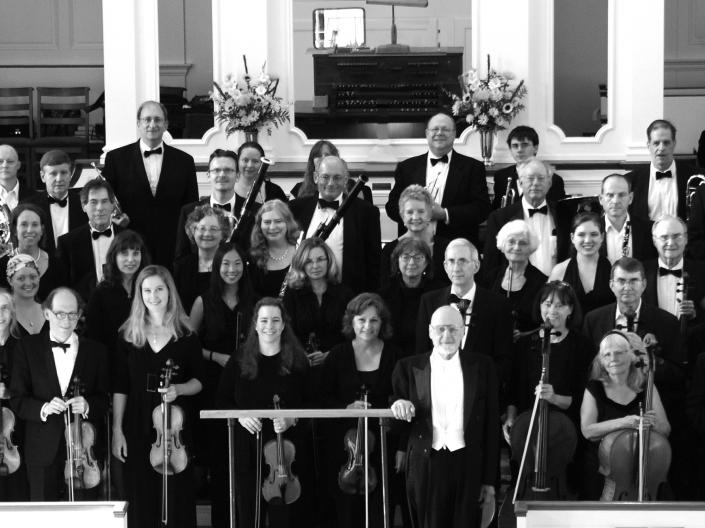 Group of people standing on a stage with instruments in hand