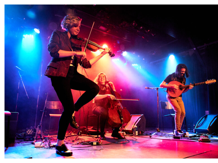 musicians with fiddle, cello and bouzouki playing and step dancing