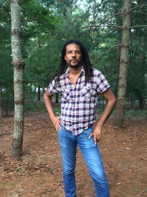 colson whitehead posing in forest