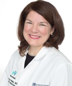 Photograph of Dr. Vanessa Maier, a white woman with brown hair wearing a white lab coat and smiling
