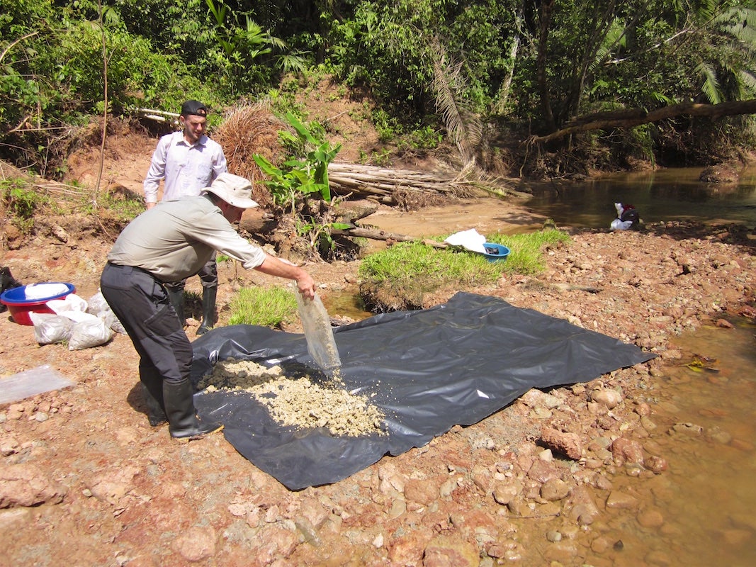 Spreading sediment to dry soil.