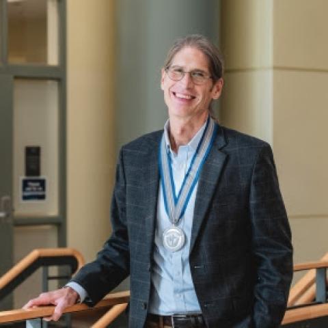 Dr. Diehl smiling with award
