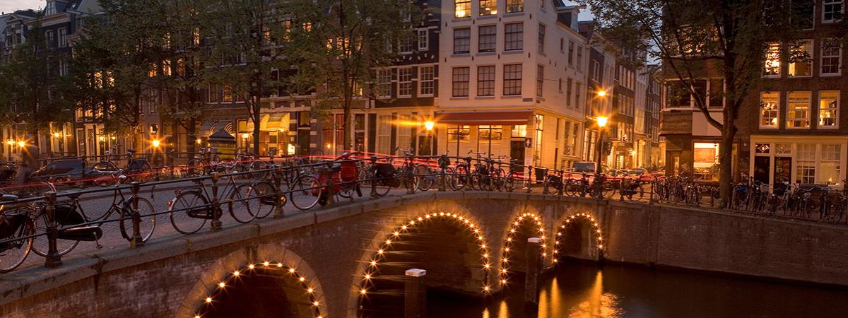 A bridge in Amsterdam with lights on it. 