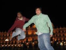 Two boys jumping in the air.