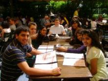 Group of students sitting at a table outside for lunch. 
