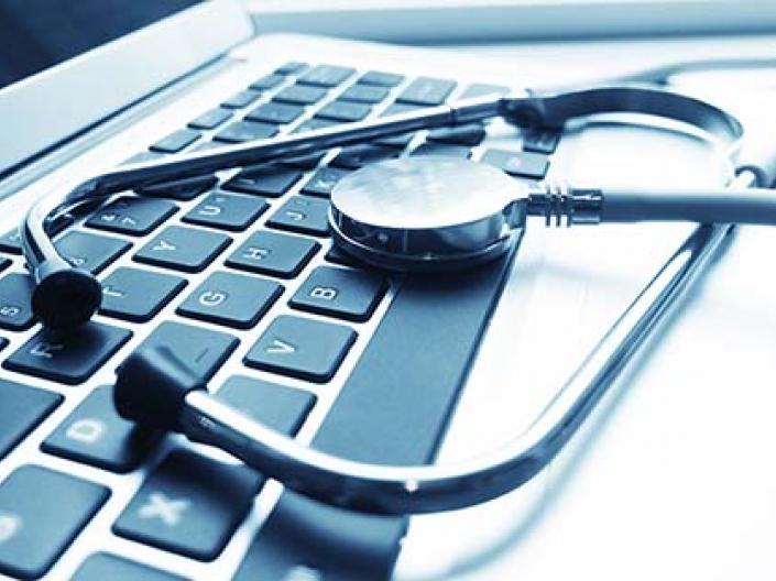 Picture of a stethoscope on top of a computer keyboard