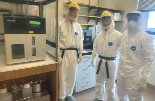 Three lab members dressed in protective gear in the BSL-3 lab for a flow-sorting and single-cell RNAseq experiment