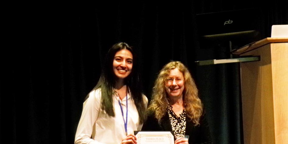 Undergrad winning an award at the 2025 CCMSB Symposium