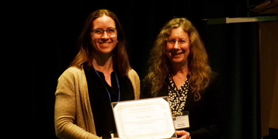 Student, Emily Klemm, receiving an award at the symposium