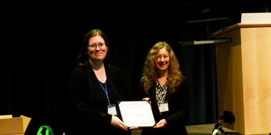 Dr. Nicole Wagner receiving an award at the symposium