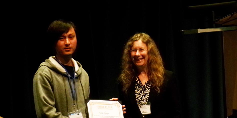 Dr. Rakesh Maharjan receiving an award at the symposium