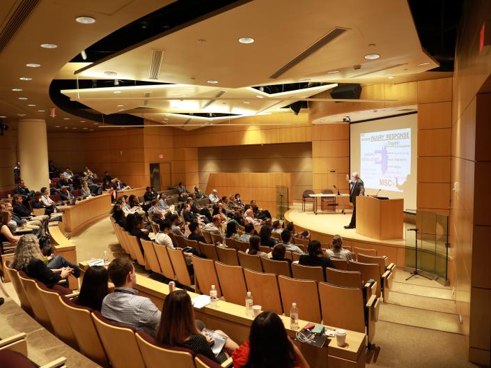 Auditorium full of attendees listening to a talk