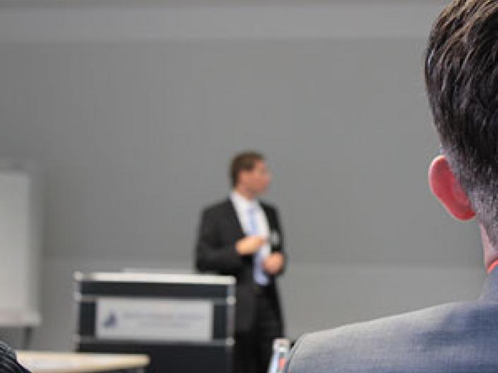 Man in a suit giving a speech
