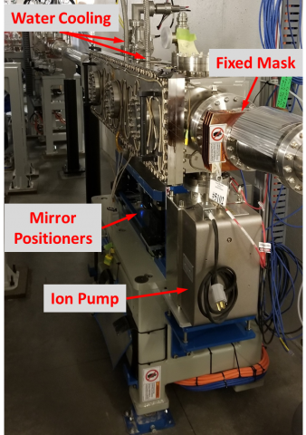 The XFP mirror chamber is mounted on a large grey stand, with motorized positioners, water cooling lines, and an ion pump visible.