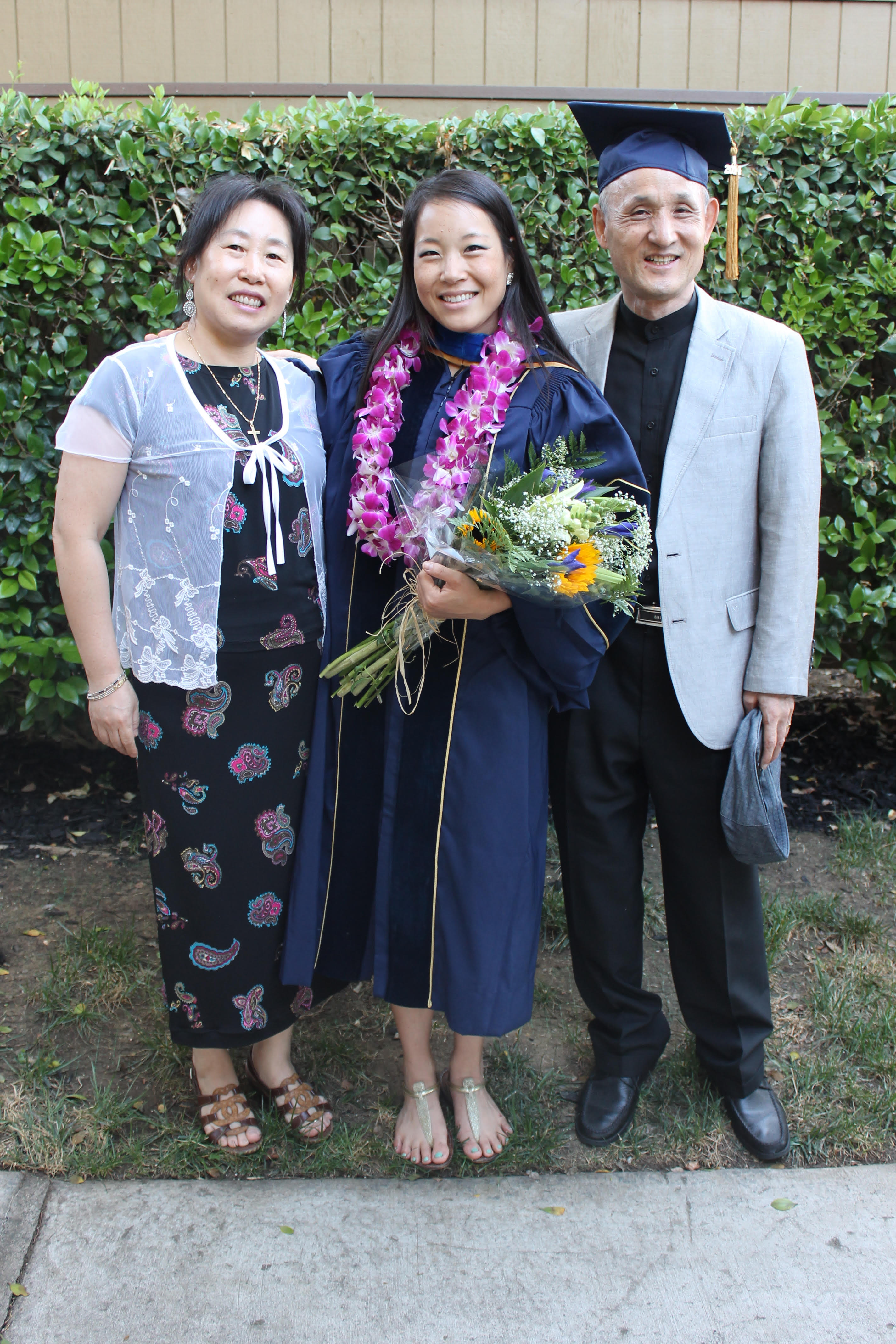 Dr. Kim-Mozeleski with her parents at her doctoral graduation. Her childhood curiosity created the environment that allows her to flourish as a researcher.