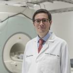Daniel Ontaneda, MD in front of machine