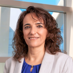Dr. Grace McComsey stands in front of a window