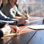 New employees sitting at a conference table during a training session