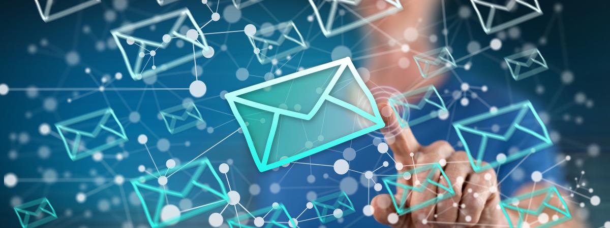 Email icons floating in air and woman reaching her finger out to touch the emails