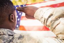 black veteran saluting flag