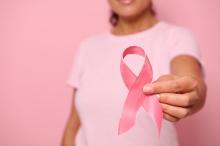 female breast cancer holding pink ribbon 