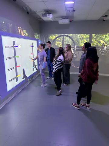 Pictures of a few students in an escape room during a transition to residency session.